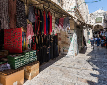 Clothes hanging at market stall in city