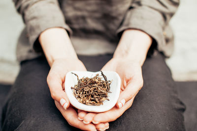 Midsection of woman holding dry food