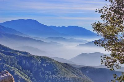 Scenic view of mountains against blue sky