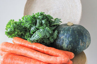 Close-up of vegetables on table against white background