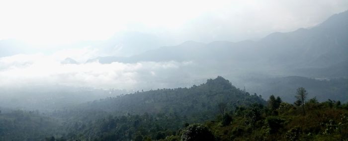 Scenic view of mountains in foggy weather