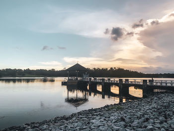 Scenic view of river against sky during sunset