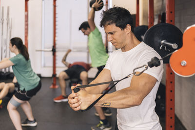 Group of beginners athletes exercising in a personal class with a private trainer. various exercises