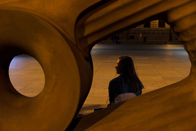 Rear view of woman standing in corridor