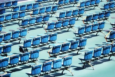 High angle view of chairs against blue sky
