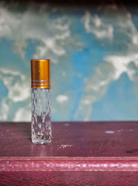 Close-up of glass of water on table against sea