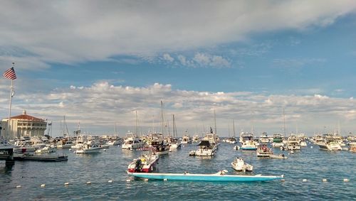 Sailboats in sea against sky