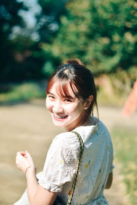 Side view of young woman standing on field