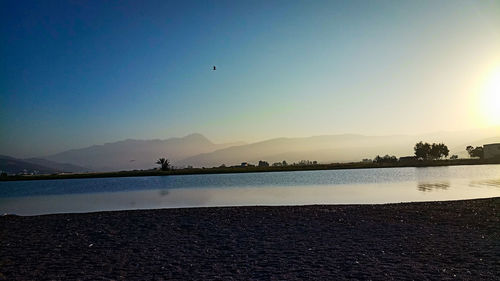 Scenic view of lake against sky during sunset