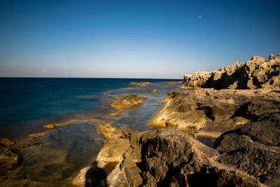 Scenic view of sea against clear blue sky
