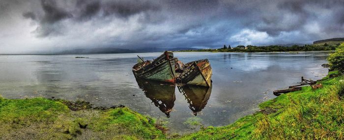 Scenic view of sea against storm clouds