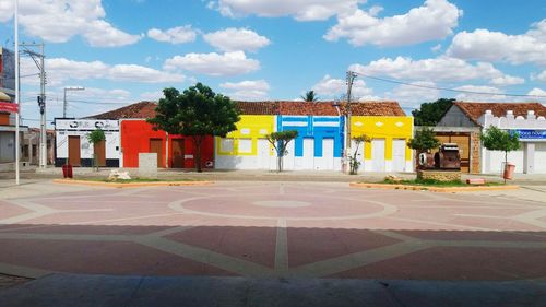 Houses by street against sky in city