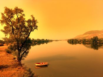 Scenic view of lake against sky during sunset