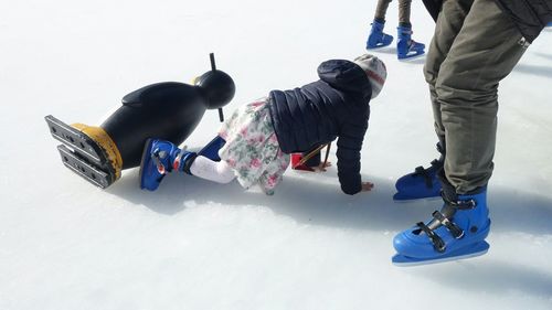 Low section of people walking in snow