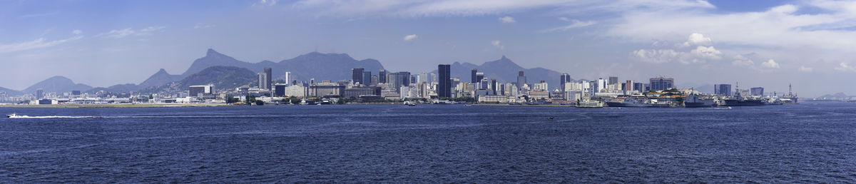 Panoramic view of sea and buildings against sky