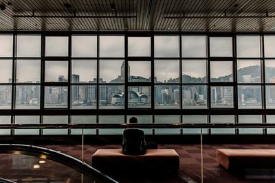 Rear view of man sitting on sofa at hong kong museum of art