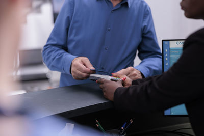 Midsection of man working in office