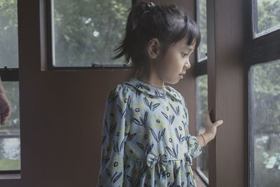 Woman looking through window