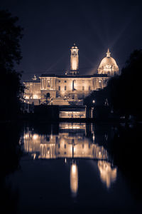 Reflection of illuminated building in water at night