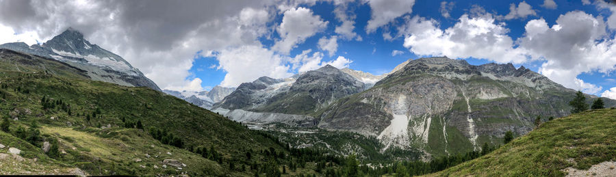 Scenic view of mountains against cloudy sky