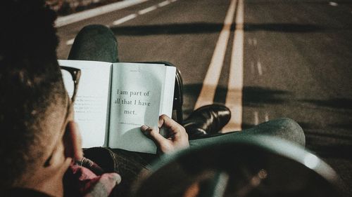 High angle view of man reading book