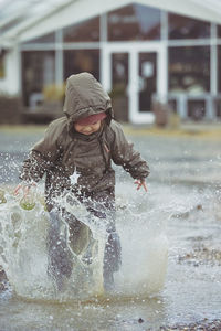 Side view of boy playing in sea