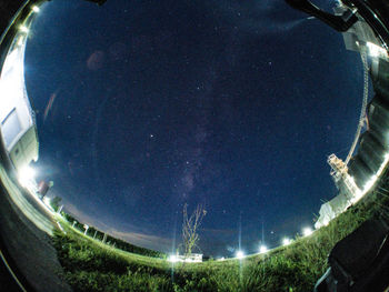 Panoramic view of illuminated plants against sky at night