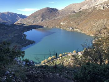 Scenic view of lake by mountains against sky