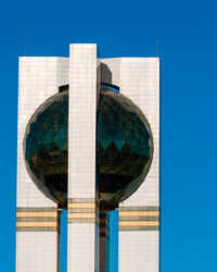 Low angle view of modern building against blue sky