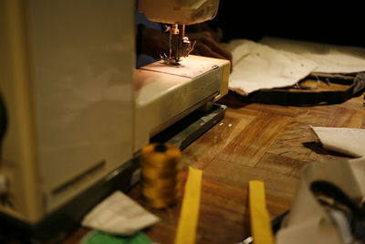 Close-up of sewing machine part on table