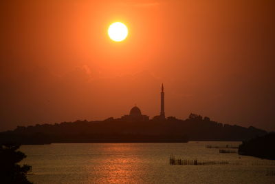 Silhouette temple against sky during sunset