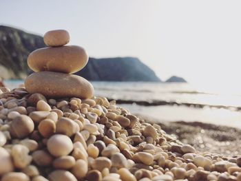 Close-up of pebbles on beach against clear sky