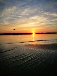 Scenic view of sea against orange sky