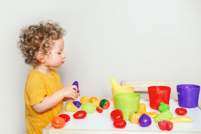 Cute boy playing with toy toys
