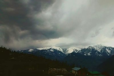 Scenic view of snow covered mountains against sky