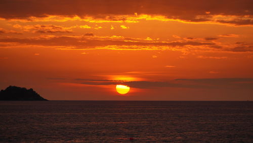 Scenic view of sea against romantic sky at sunset