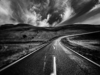 Empty road along landscape