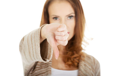 Portrait of beautiful woman with hand against white background