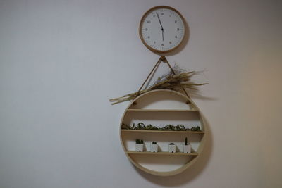 Close-up of clock against wall