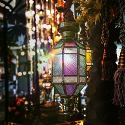 Close-up of illuminated lanterns hanging at night