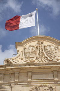 Low angle view of flags against sky