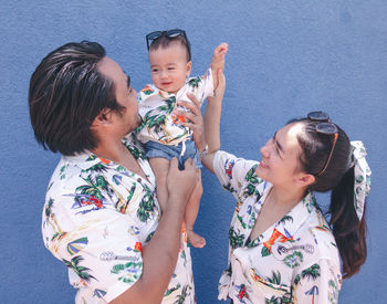 High angle view of mother and daughter against white background