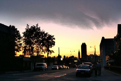 Traffic on road at sunset