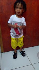 Portrait of cute girl standing on floor