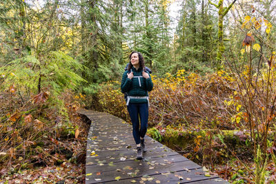 Rear view of woman walking on boardwalk