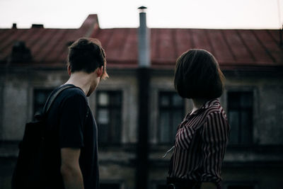 Rear view of man and woman outdoors