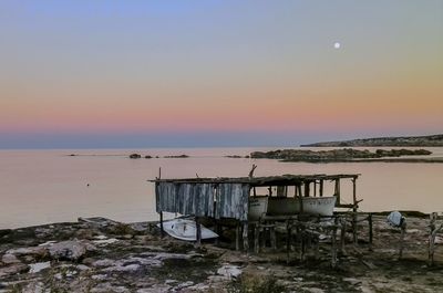 Scenic view of beach against sky during sunset