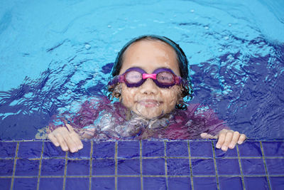 High angle view of girl swimming in pool