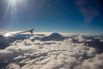 Airplane flying over cloudscape against sky