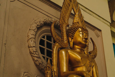 Low angle view of angel statue against building